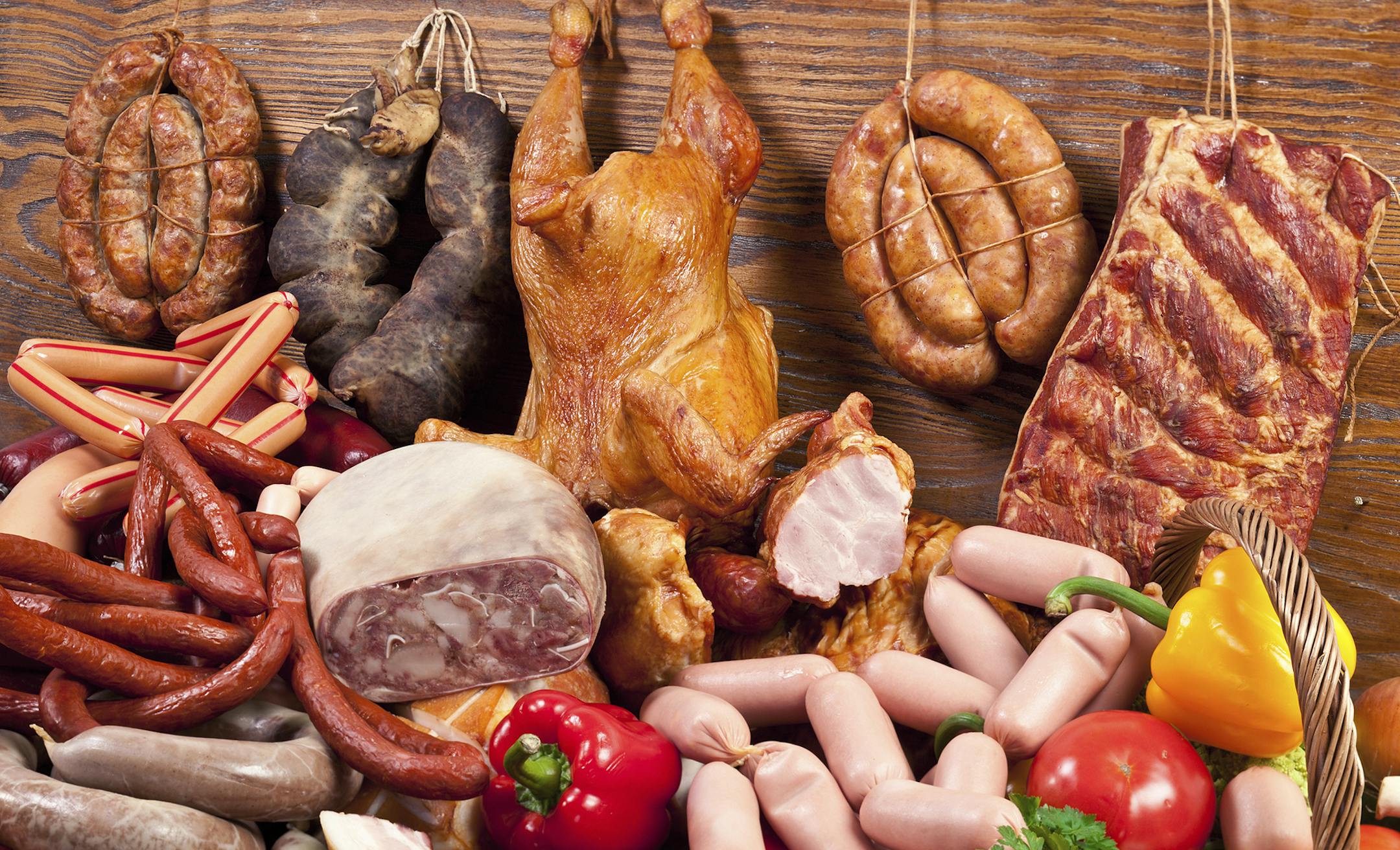 Variety of sausage products and vegetables. Close-up shot.