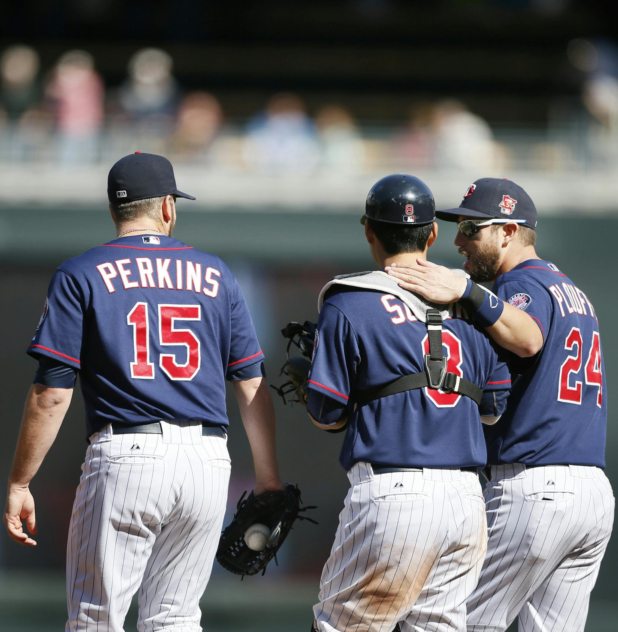 Minnesota Twins catcher Kurt Suzuki (8) center and teammates Glen Perkins left and Trevor Plouffe walked off the field after beating the Baltimore Orioles 5-2 at Target Field Sunday May 4, 2014 in Minneapolis, MN. ] Jerry Holt Jerry.holt@startribune.com
