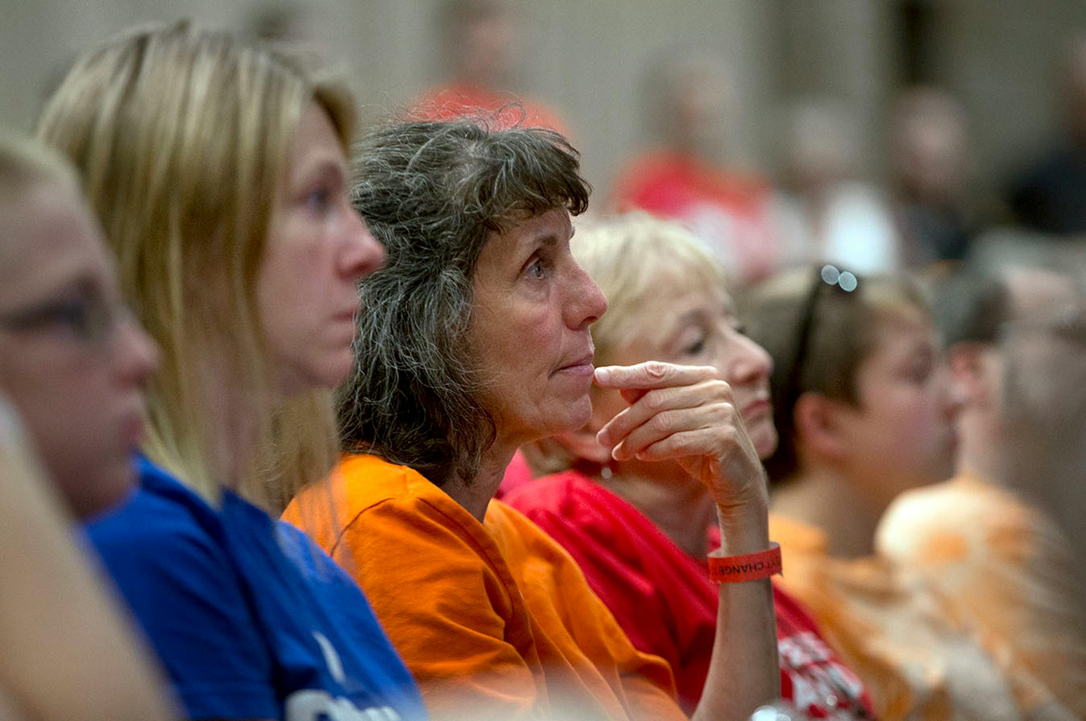 An audience member listens intently to the stories shared by students on the panel.