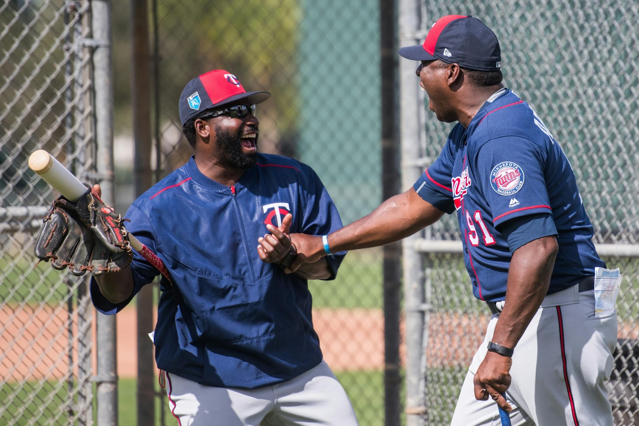 Twins AA manager Tommy Watkins and AA pitching coach Ivan Arteaga doubled up in laughter about something while walking off the field.