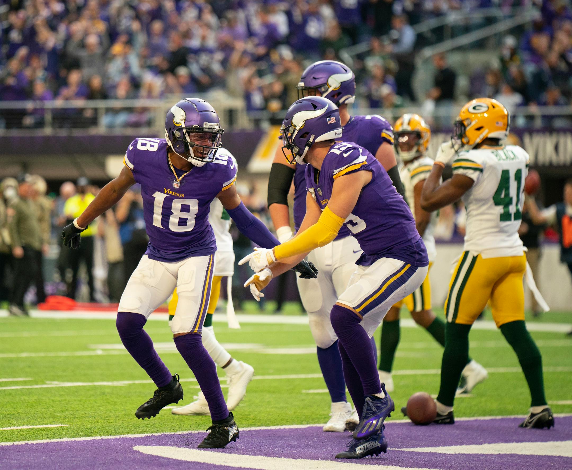 Minnesota Vikings wide receiver Justin Jefferson (18) and Minnesota Vikings wide receiver Adam Thielen (19) celebrated Jefferson's nine yard touchdown reception in the third quarter.