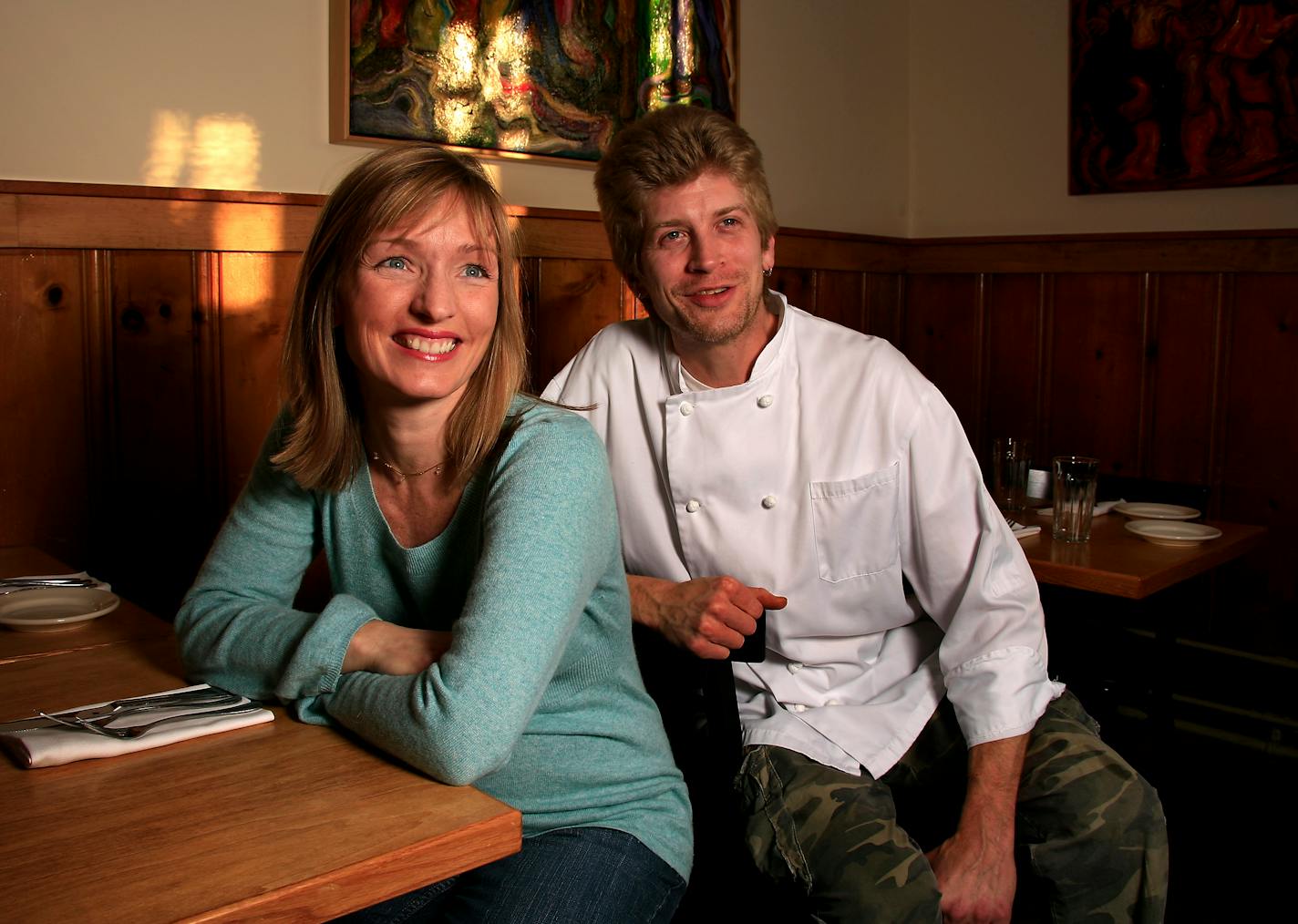 Jill Wilson and chef Ian Pierce sit in the main dining room at the 128 Cafe. Wilson is the new owner of the restaurant that reopened in November after under going some renovations, but they left the pine paneling alone, as they want to be known as a neighborhood restaurant.