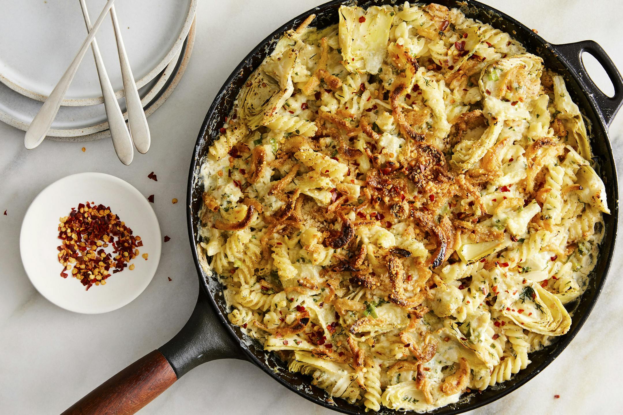 Baked artichoke pasta with creamy goat cheese, showered with canned fried onions for crunch.