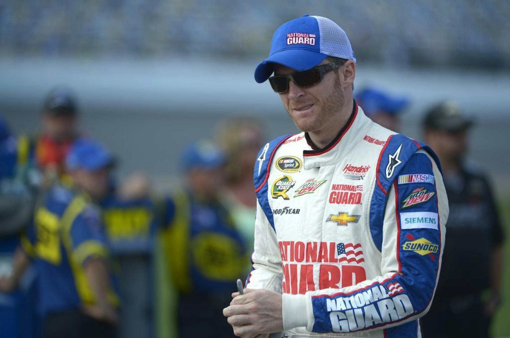 Dale Earnhardt Jr. walks down pit road during qualifying for the NASCAR Sprint Cup auto race at Daytona International Speedway in Daytona Beach, Fla., Friday, July 5, 2013.