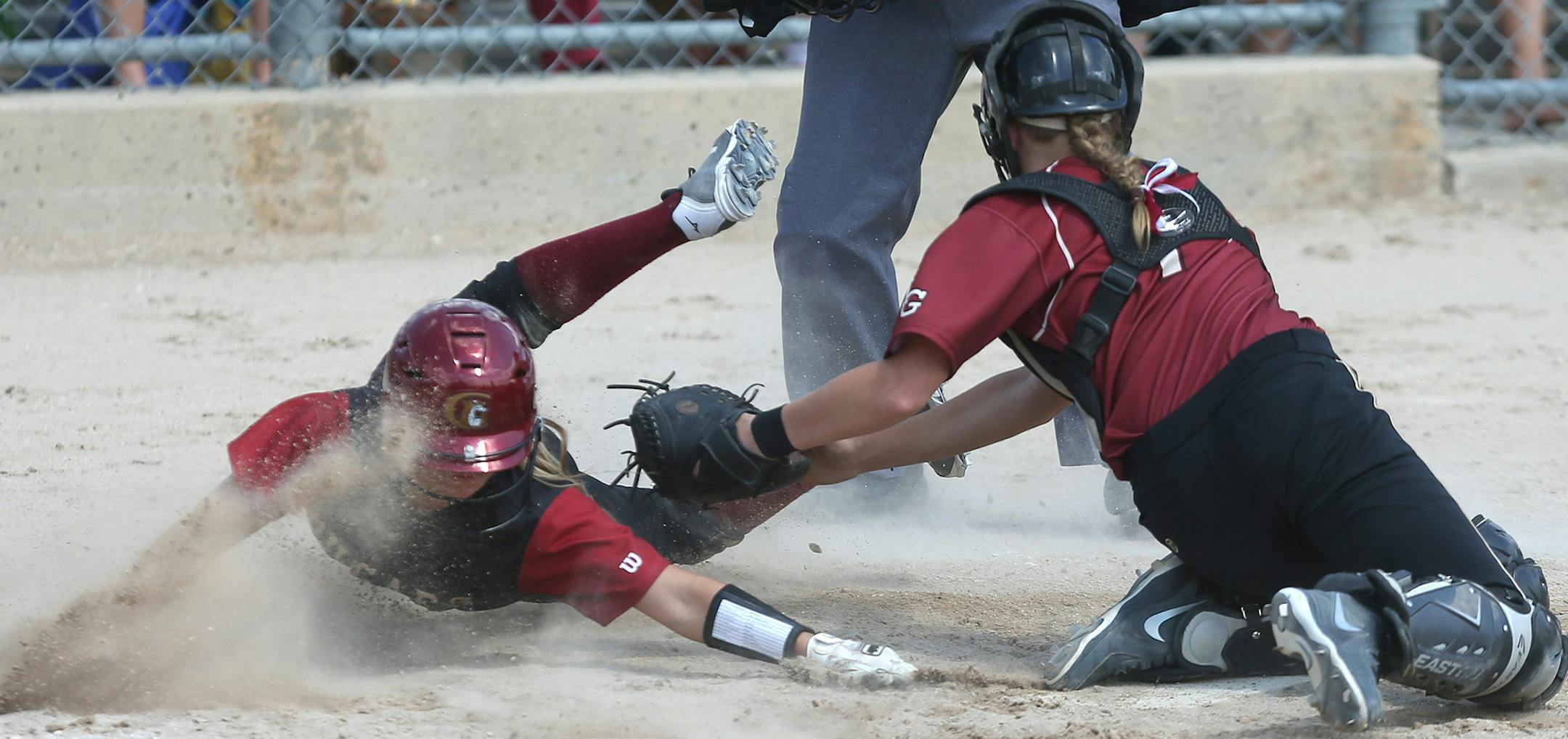 Lakeville South's Michaela Thielen slid safely into home plate for the go ahead run against Maple Grove catcher Jordan Mauch in the sixth innning ] (KYNDELL HARKNESS/STAR TRIBUNE) kyndell.harkness@startribune.com Class 3A softball state Championship Lakeville South 4, Maple Grove 3 in North Mankato, Min. Friday, June 6, 2014.