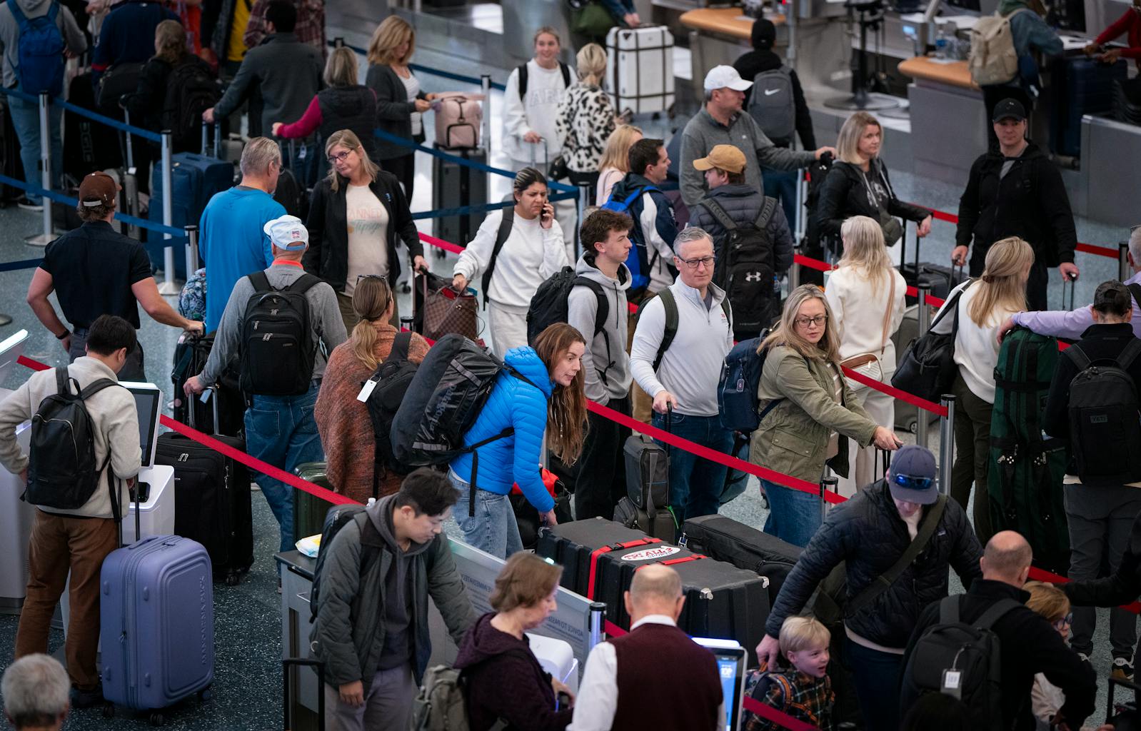 Travelers line up at the Delta check-in area in Terminal 1 at Minneapolis-St. Paul International Airport on Friday.