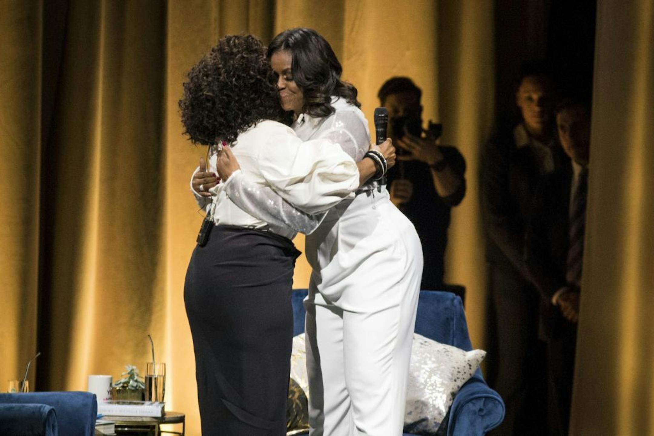 Former first lady Michelle Obama, right, hugs Oprah Winfrey during a kickoff event for Obama's new book "Becoming" at the United Center in Chicago, Tuesday night, Nov. 13, 2018.