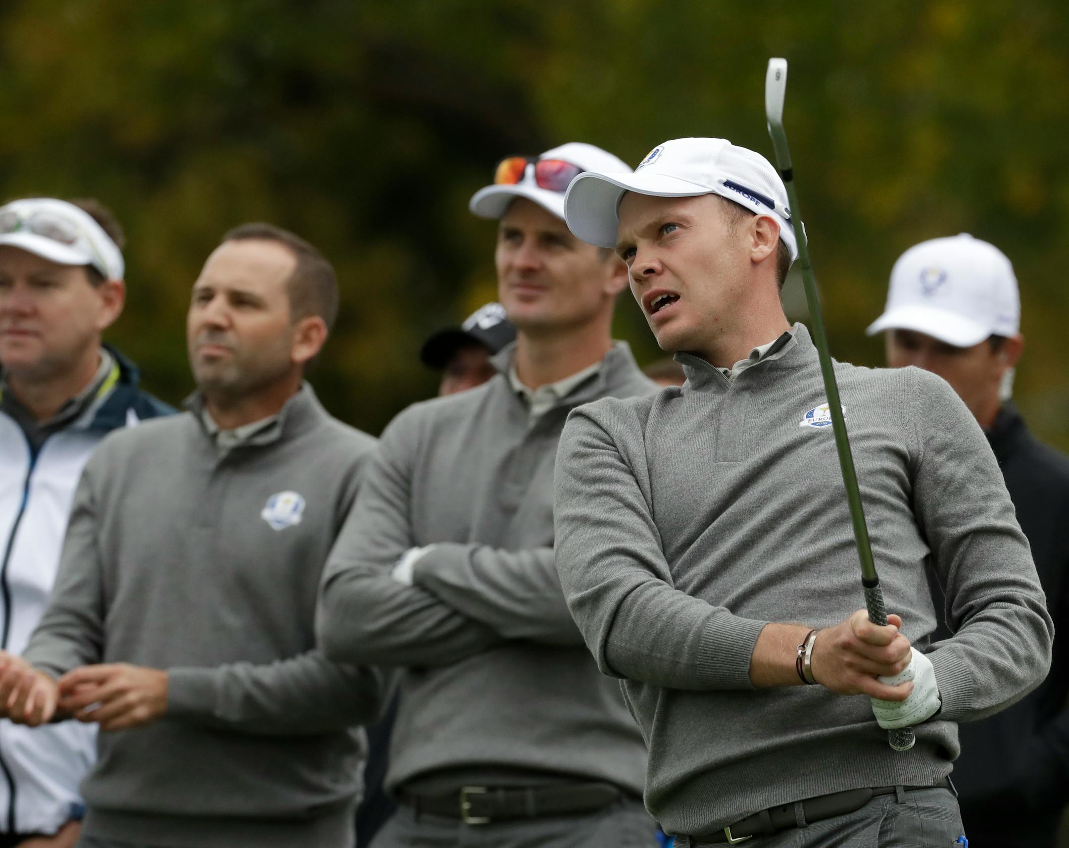 Europe's Danny Willett watches his drive with teammate Justin Rose and Sergio Garcia during a practice round for the Ryder Cup Wednesday.