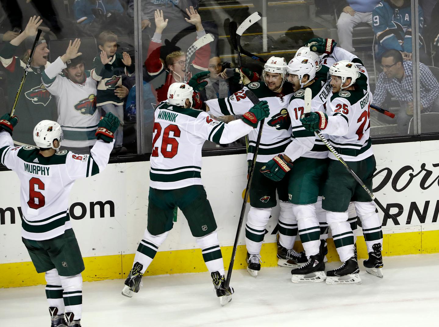 Minnesota Wild's Nino Niederreiter (22), center, is mobbed by teammates after his game-winning goal during overtime of an NHL hockey game against the San Jose Sharks, Sunday, Dec. 10, 2017, in San Jose, Calif. Minnesota won 4-3. (AP Photo/Marcio Jose Sanchez)