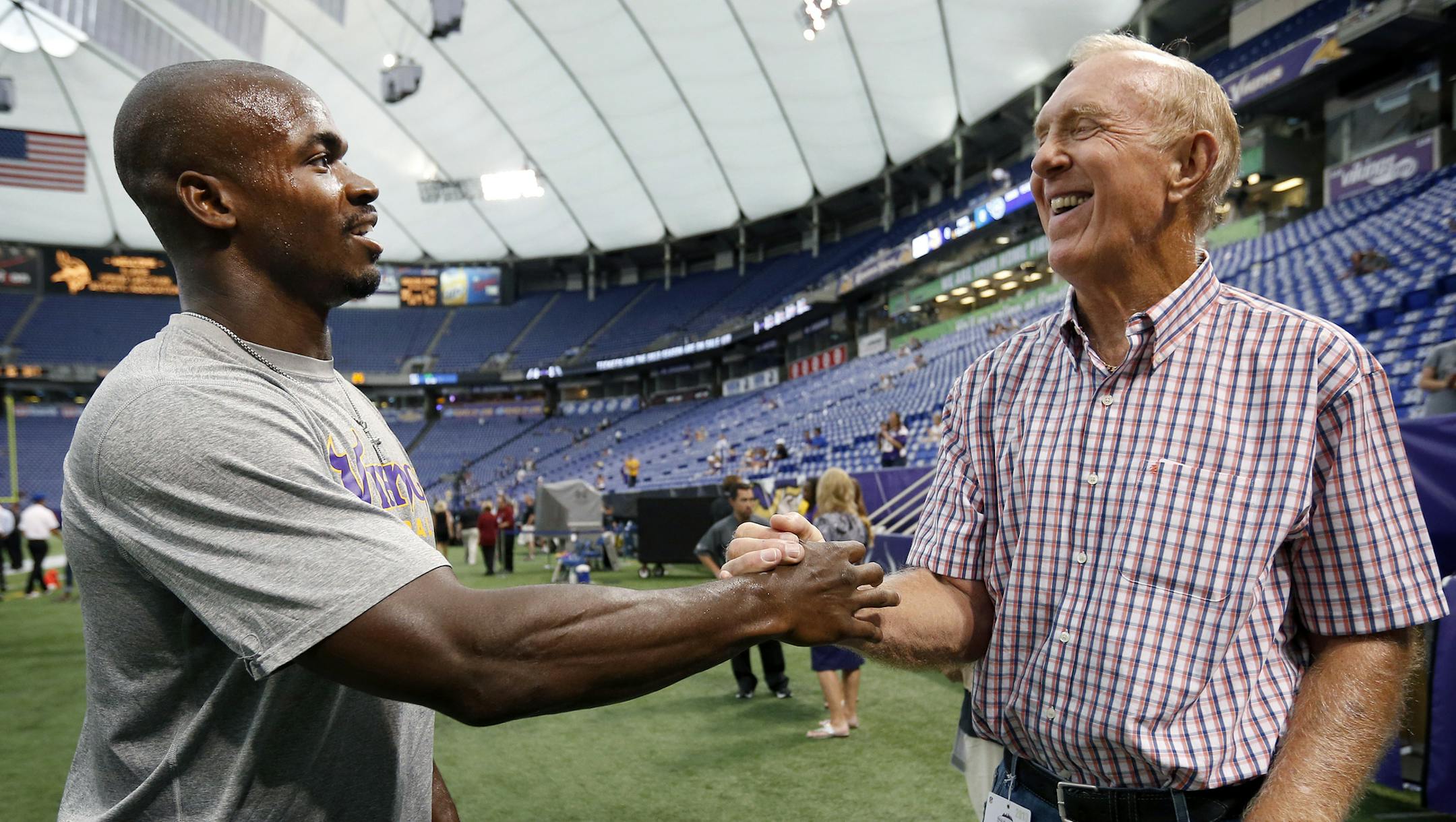 Vikings running back Adrian Peterson spoke with former Minnesota Vikings player Bob Lurtsema on the sidelines before Thursday night's game. ] CARLOS GONZALEZ cgonzalez@startribune.com August 29, 2013, Minneapolis, Minn., NFL, Mall of America Field The Metrodome, Minnesota Vikings vs. Tennessee Titans ORG XMIT: MIN1308291804548605