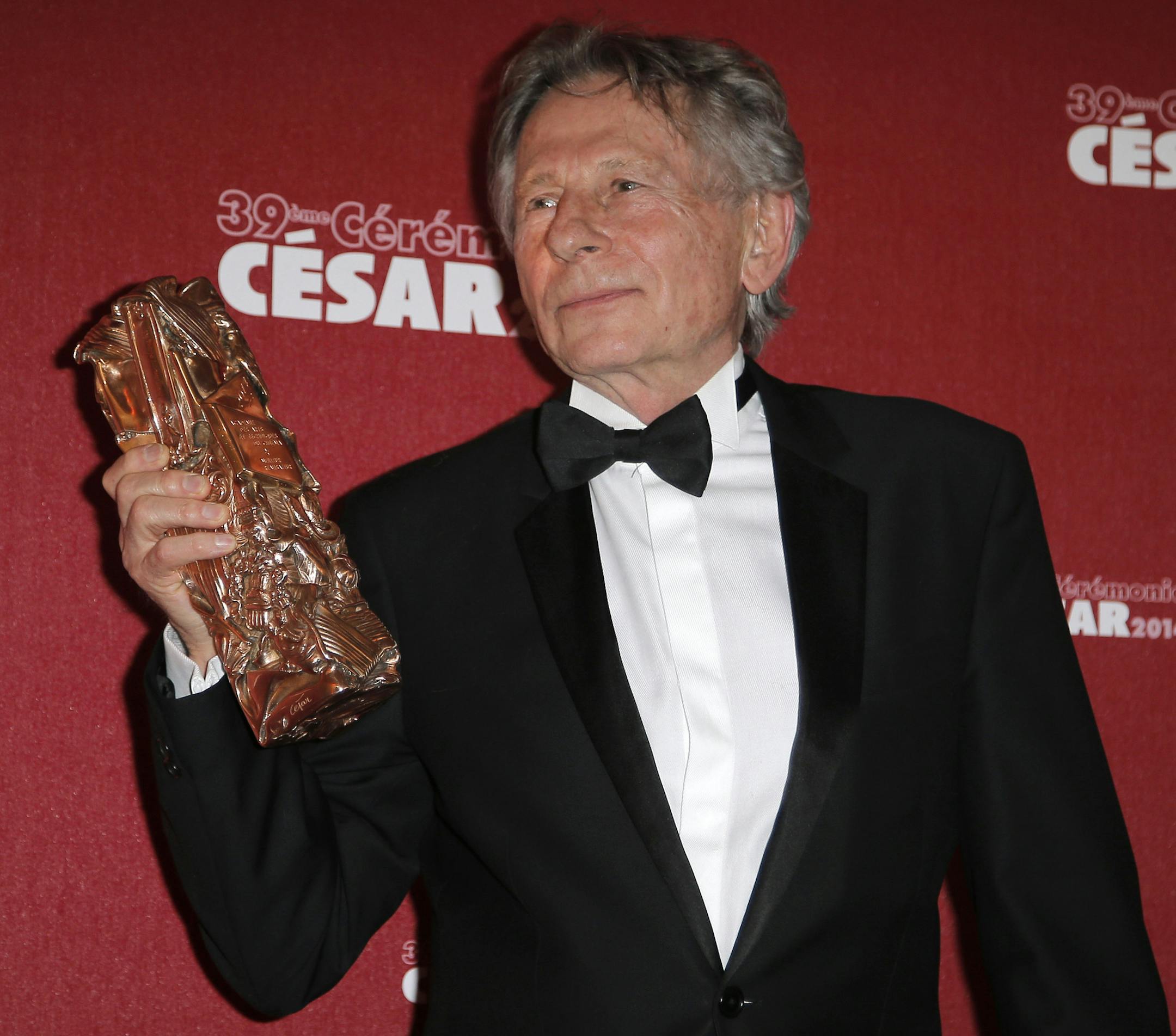 FILE - In this Feb. 28, 2014 file photo Polish-French film director Roman Polanski holds his best director award during the 39th French Cesar Awards Ceremony in Paris. (AP Photo/Lionel Cironneau, File)