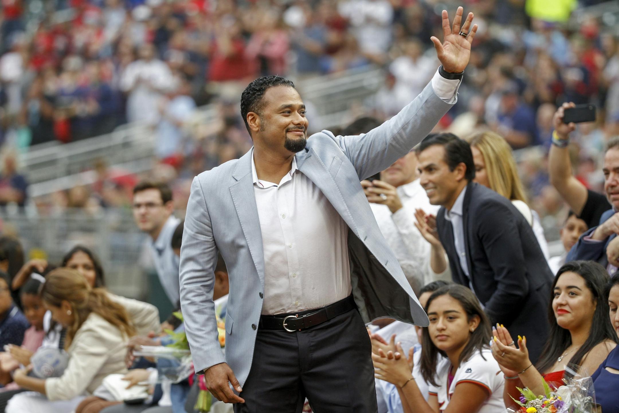 Former Minnesota Twins pitcher Johan Santana acknowledges the crowd as he is introduced at his induction ceremony to the Twins Hall of Fame before a baseball game against the Kansas City Royals, Saturday, Aug. 4, 2018, in Minneapolis.