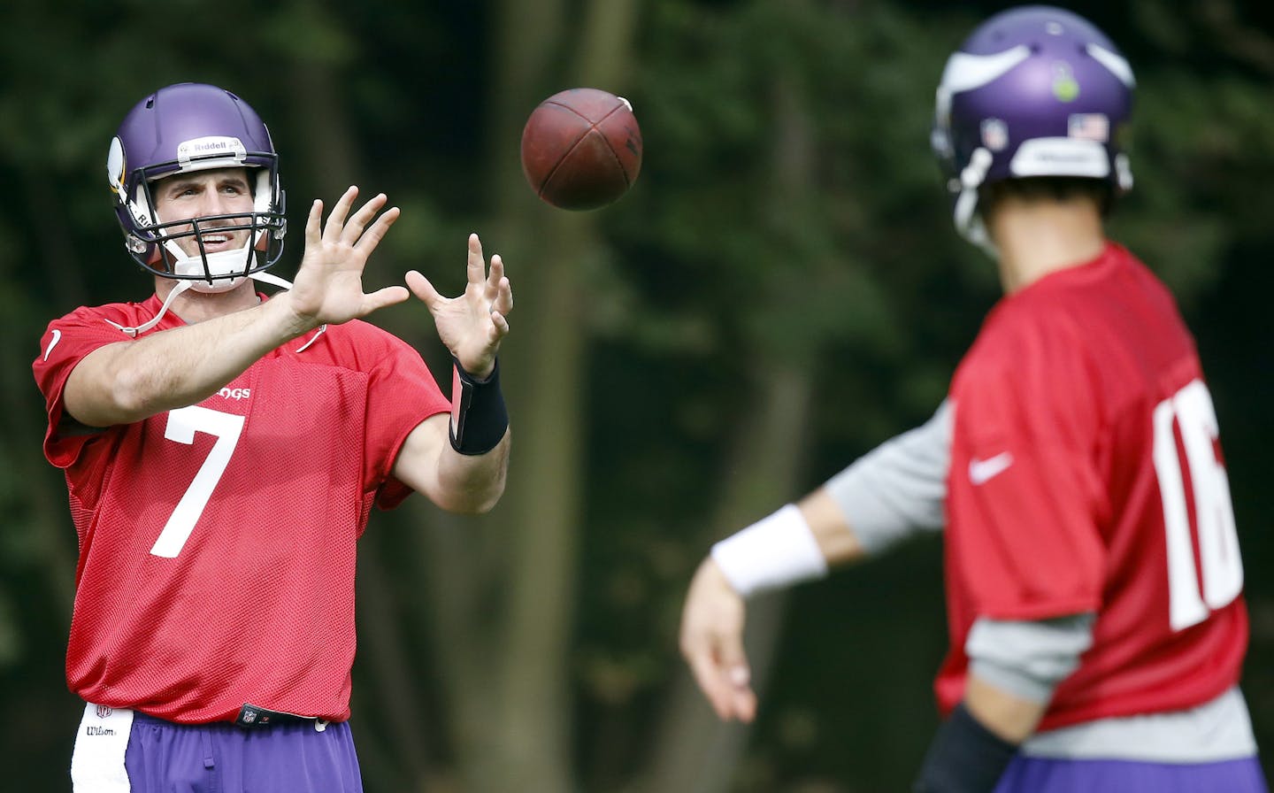 Minnesota Vikings quarterback Christian Ponder (7) played catch with Matt Cassel (16) during practice on Wednesday at The Grove in Watford, England.