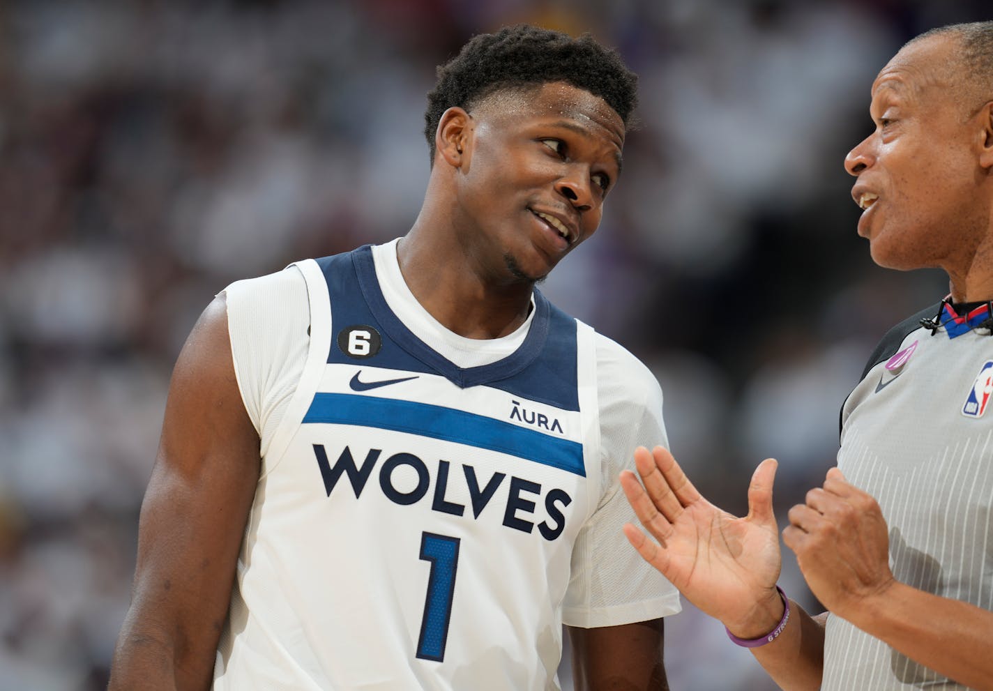 Minnesota Timberwolves guard Anthony Edwards, left, talks with referee Rodney Mott after Edwards was called for a foul in the second half of Game 1 of an NBA basketball first-round playoff series against the Denver Nuggets Sunday, April 16, 2023, in Denver. (AP Photo/David Zalubowski)