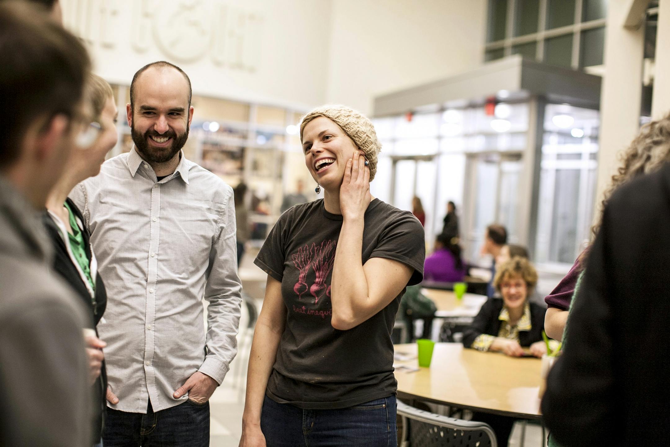 Emily Torgrimson visits with guests at Eat for Equity's community feast benefitting Urban Ventures at the Urban Ventures headquarters in Minneapolis January 31, 2015. Regular guest Ted Schatz, left, had Eat for Equity cater his wedding.