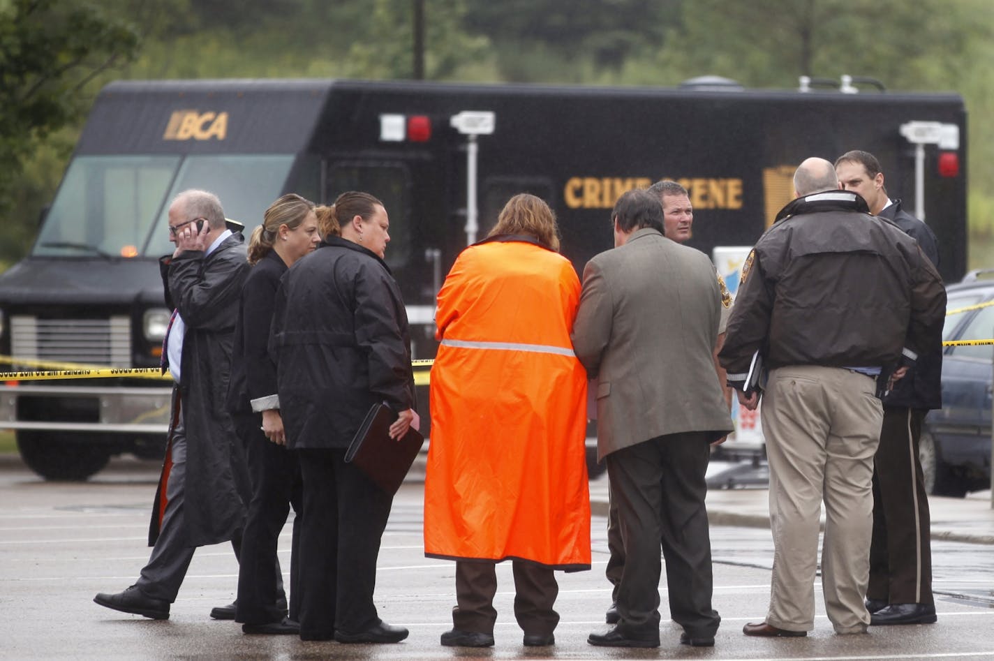 At the Holiday gas startion on Hwy. 96 near the the 35W exit in Arden Hills on Aug. 11, 2104, investigators examined the evidence at the site of a fatal shooting. The suspect drove away in a BMW.