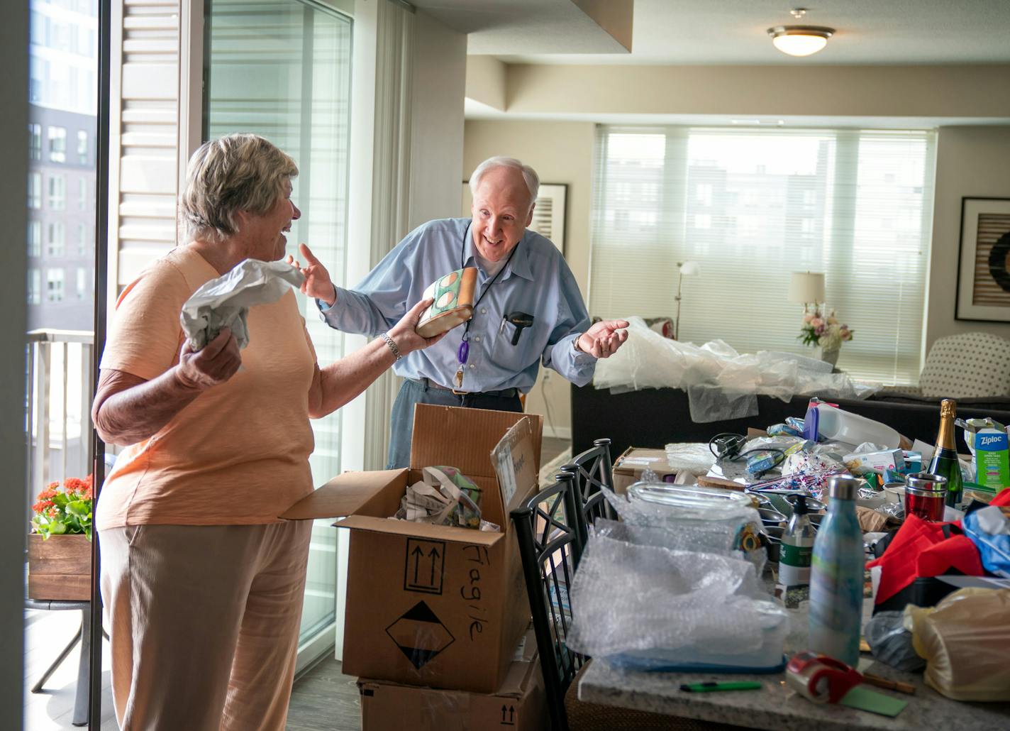 Janet Jacobs laughed with delight at her posessions as she unpacked a box she packed three years ago. Fred and Janet Jacobs were the first residents to move into the Pillars at Prospect Park, an age-restricted continuum of care building. They were still unpacking boxes after the move. ] GLEN STUBBE • glen.stubbe@startribune.com Thursday, May 28, 2020 Janet and Fred Jacobs have been on a waiting for nearly three years to move into an independent living building for seniors where they'll have acce