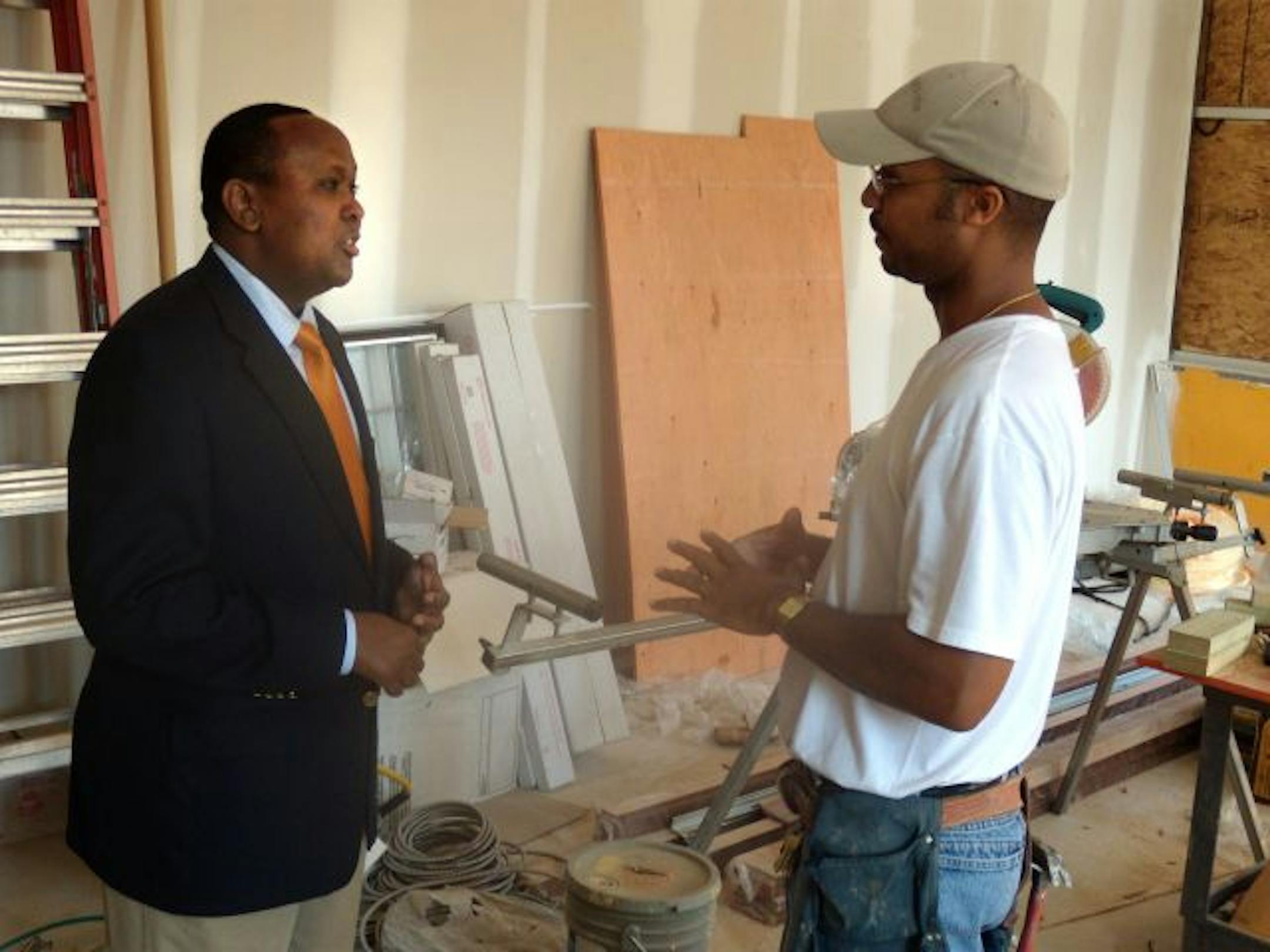 Hussein Samatar, executive director of the African Development Center, and project manager Kenneth Allen of Flannery Construction, discuss progress on the coffee shop that will be inside the organization's headquarters that will open in October.