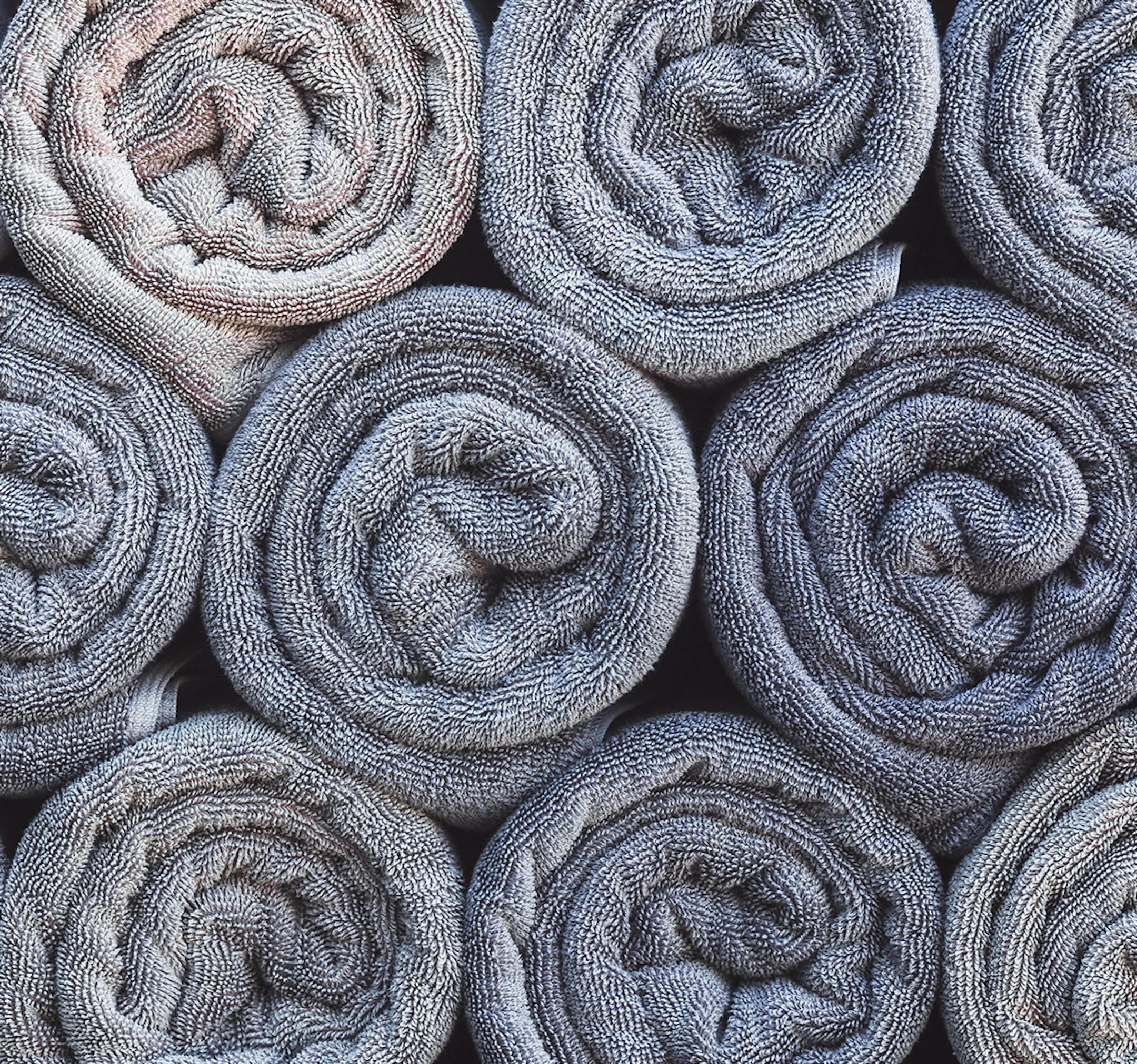 Stack of rolled towels in hotel near beach