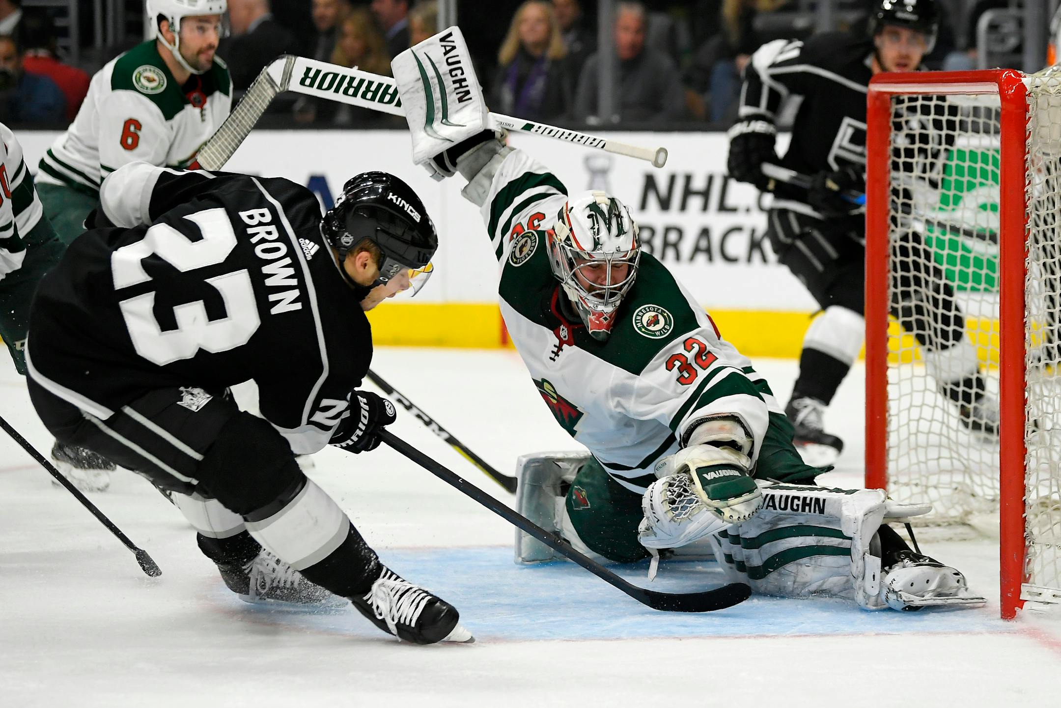 Los Angeles Kings right wing Dustin Brown, left, tries to get a shot past Wild goaltender Alex Stalock during the second period. Brown scored four goals in the game.