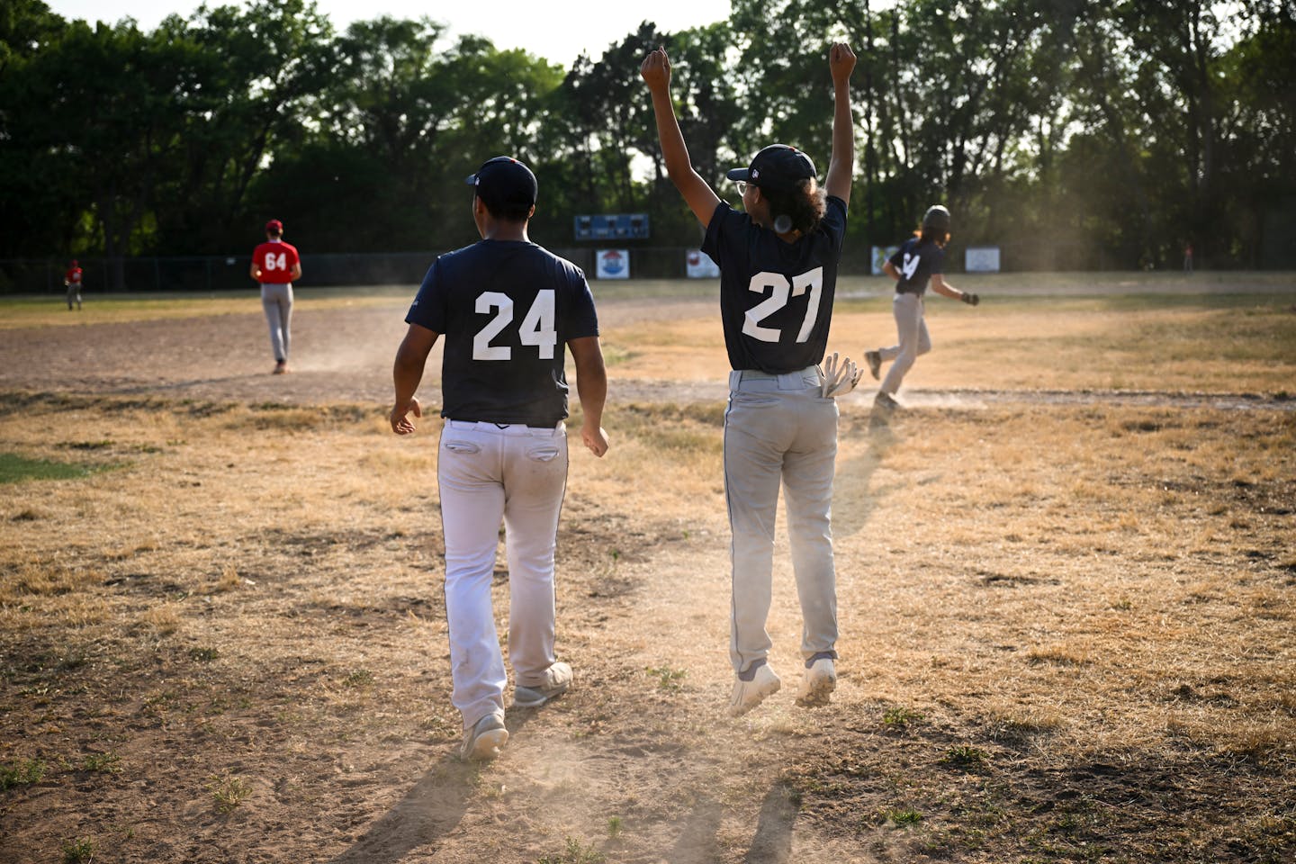 The Midway Blazers' Kylee Erb (27) leaps while celebrating a teammates near home-run hit during a U15 baseball game between the Midway Blazers and St. Agnes Thursday, June 22, 2023, at East Twins Babe Ruth Field in St. Paul, Minn. ] AARON LAVINSKY • aaron.lavinsky@startribune.com