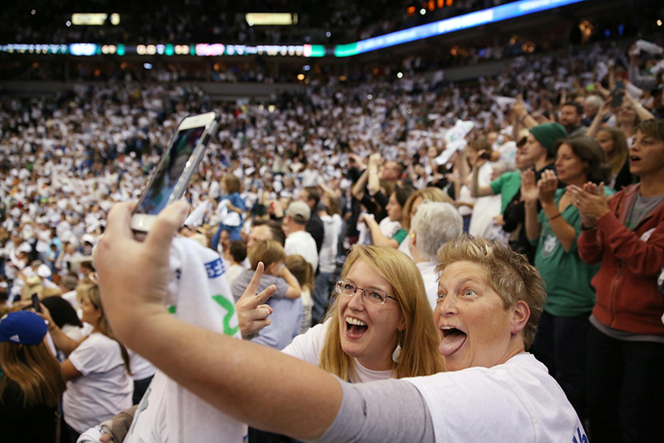 Fans Jeanne Wodarz of White Bear Lake, right, and Kristin Magoris of Minneapolis celebrate the Minnesota Lynx winning the WNBA title.