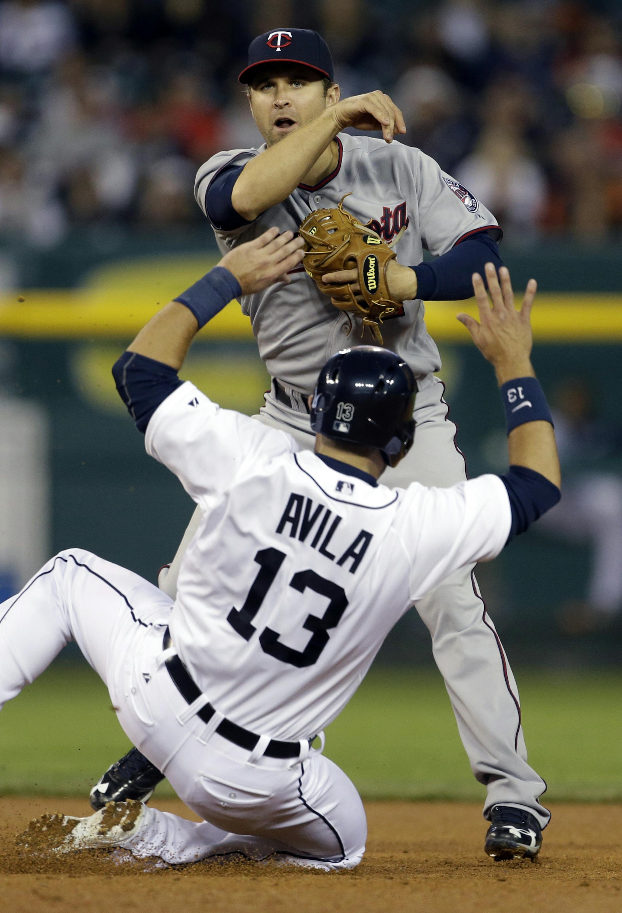 Detroit Tigers' Alex Avila is thrown out by Minnesota Twins second baseman Brian Dozier after Tigers' Omar Infante grounded out to the shortstop during the fifth inning of a baseball game in Detroit, Monday, April 29, 2013. (AP Photo/Carlos Osorio)