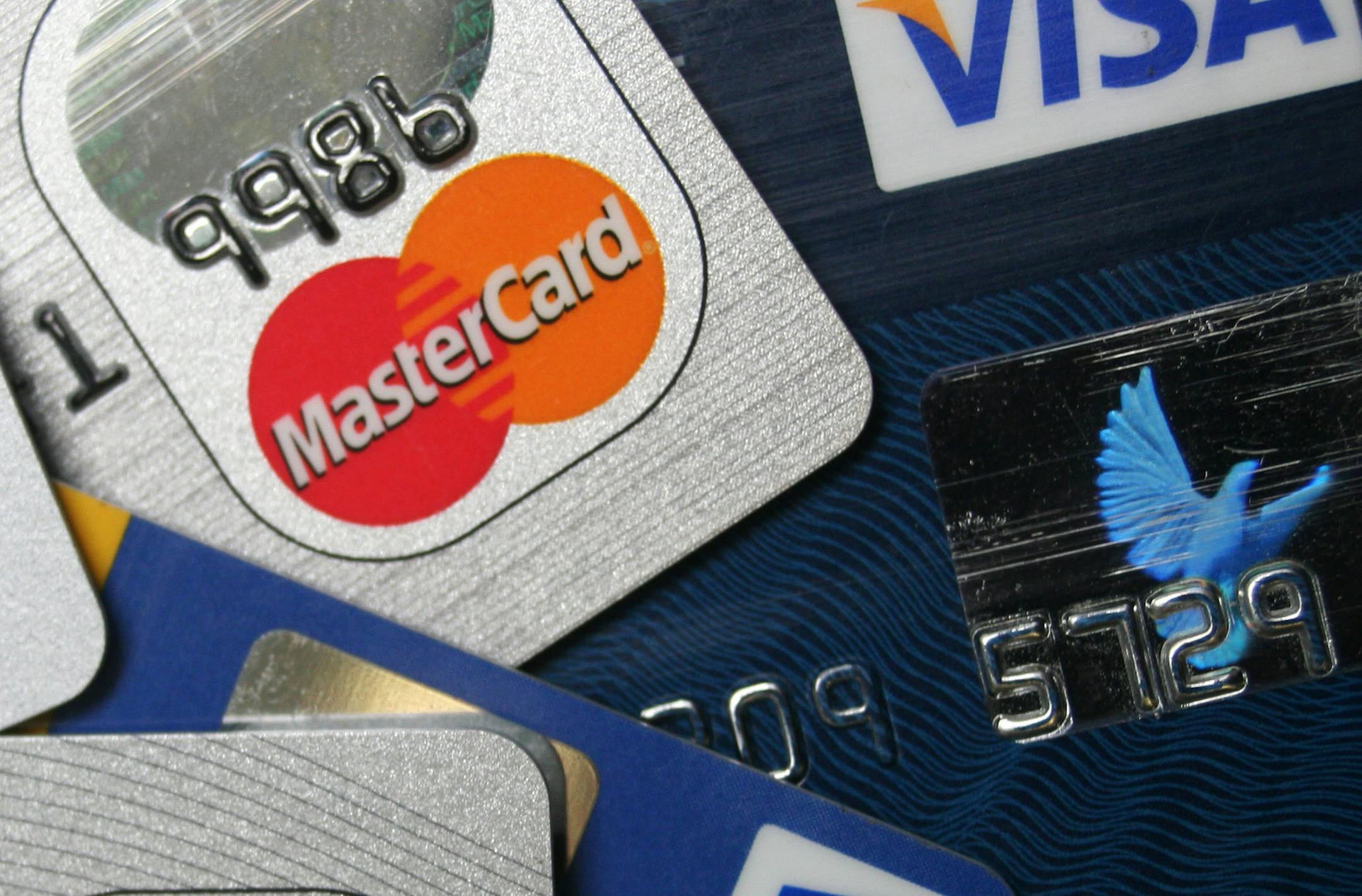 FILE - This file photo taken Nov. 18, 2009, shows a pile of MasterCard and VISA credit cards in Frankfurt, Germany. Heads are still spinning over credit card bills and charges. A law that went into effect in February 2010, requires banks to provide numerous consumer protections, including clearer monthly statements. Yet confusion about some practices remains widespread. (AP Photo/Jochen Krause, File)