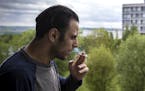 Mohammed Hassan smoked a cigarette on the balcony of his apartment in the Gellerupparken neighborhood in Aarhus, Denmark. Hassan grew up in Gelleruppa
