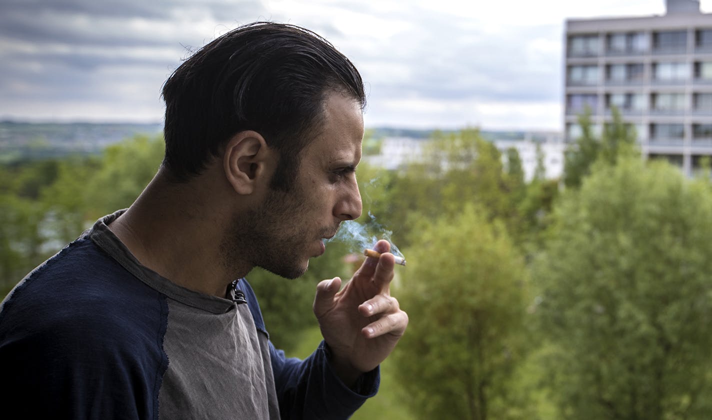 Mohammed Hassan smoked a cigarette on the balcony of his apartment in the Gellerupparken neighborhood in Aarhus, Denmark. Hassan grew up in Gellerupparken and says it was a wonderful place to grow up. He and other residents have recently launched a group to handle neighborhood "red alerts" after a resident's two sons left for Syria. ] RENEE JONES SCHNEIDER &#x2022; reneejones@startribune.com ORG XMIT: MIN1606271527180030