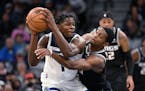 Kings guard De'Aaron Fox, right, tried to slap the ball away from Timberwolves guard Anthony Edwards during the second half