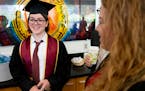 Elliott Tanner, 13, smiles while talking to his professors during a pre-graduation party Thursday, May 12, 2022 at the University of Minnesota in Minn