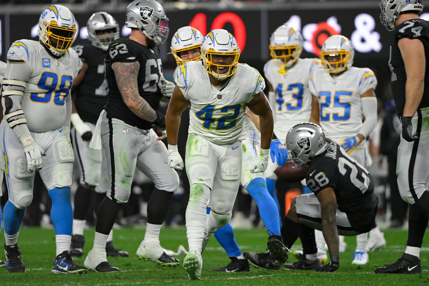 Los Angeles Chargers outside linebacker Uchenna Nwosu (42) reacts after a play against the Las Vegas Raiders during the first half of an NFL football game, Sunday, Jan. 9, 2022, in Las Vegas. (AP Photo/David Becker)