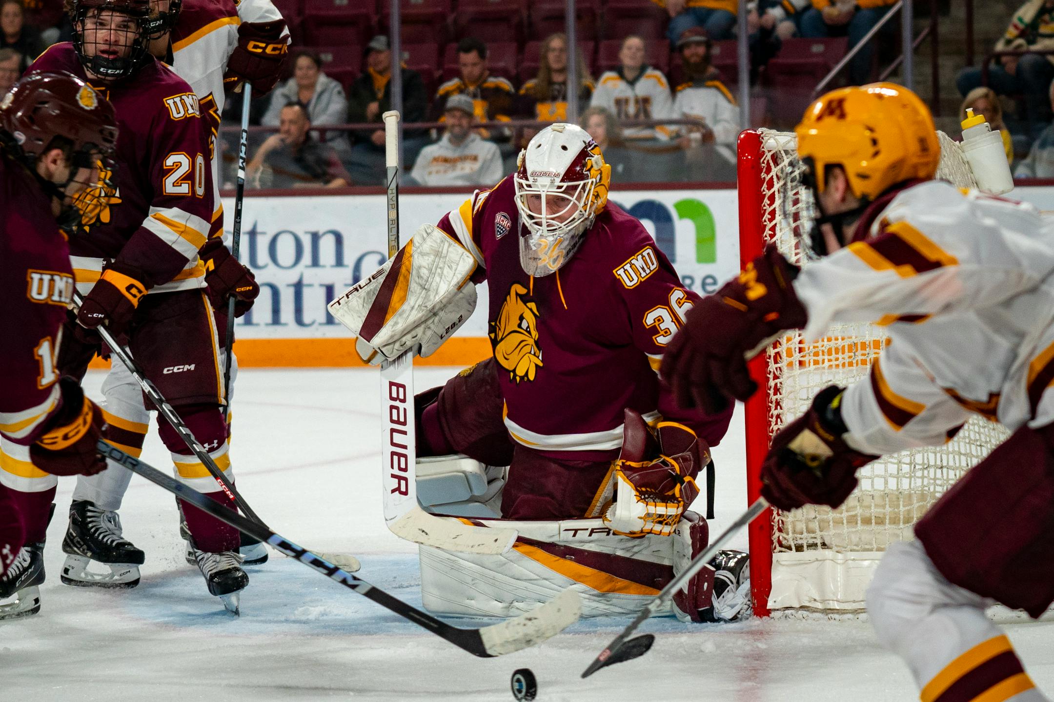 Minnesota's offense and Duluth's defense battle for the puck.