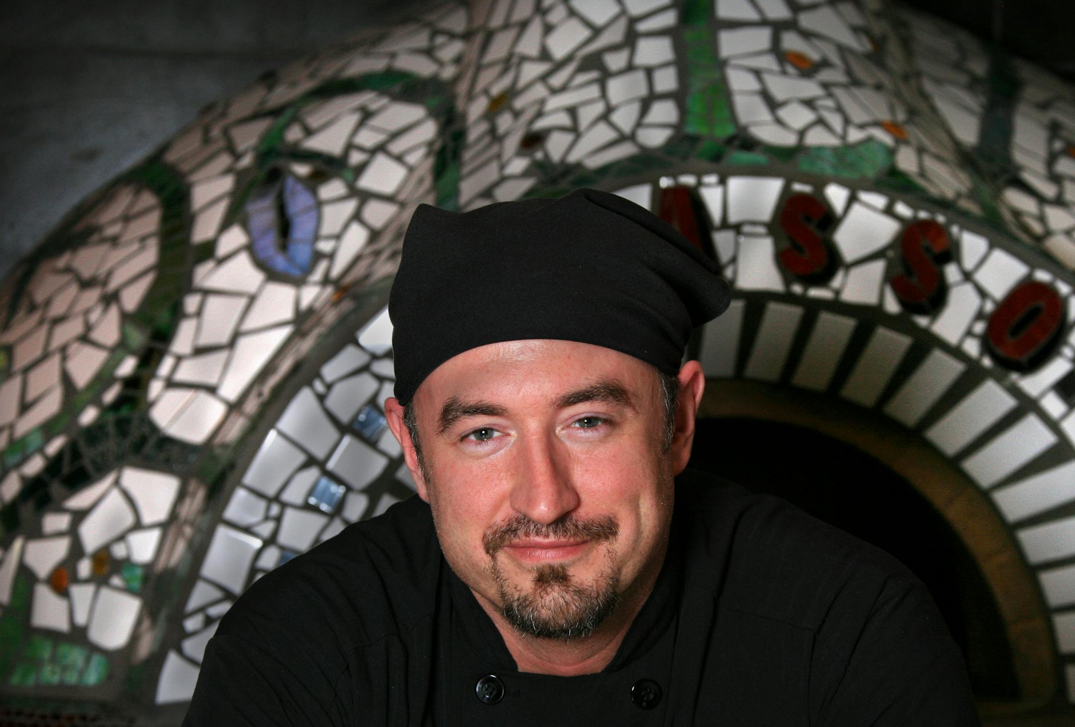 Damian Tittle, chef at Spasso in Minnetonka in front of the elaborate pizza oven.