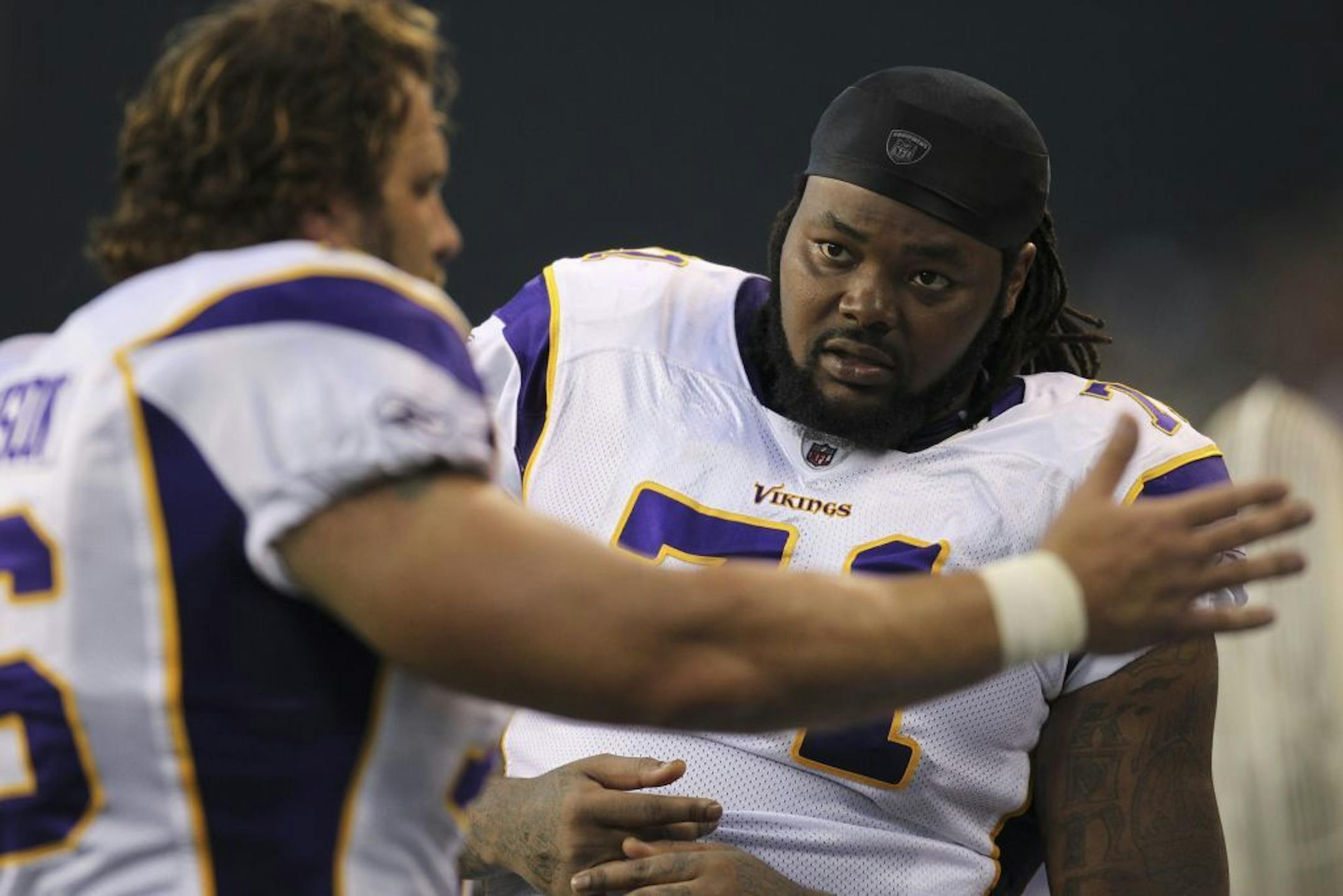 Minnesota's Phil Loadholt listened to Steve Hutchinson as they huddled on the bench in the second quarter Saturday night.