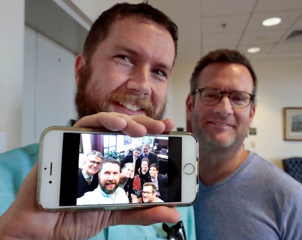 Scott Shive, left, with husband Marc Roland, held up a cell phone photo of their impromptu wedding in Lexington, Ky. On that day in June 26, 2015, a d