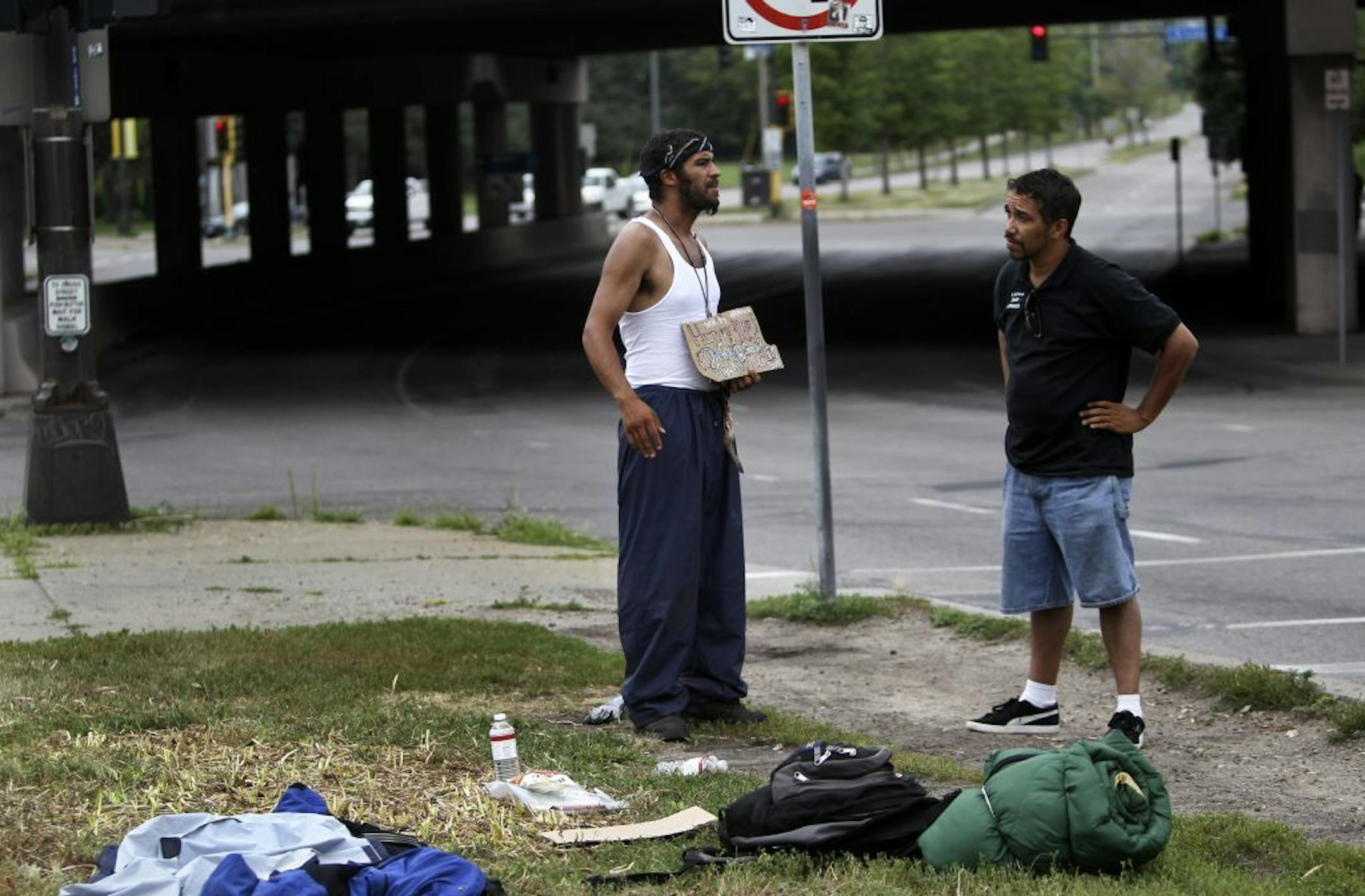 Street outreach workers like Joseph Desenclos at St. Stephen's Human Services, right, regularly canvass downtown for homeless residents and try to offer them advice and services. They say that the homeless can be prime targets for violence and Desenclos met Michael Taylor, 31, at N. 17th St. and Hennepin Ave. on his rounds checking on the homeless around the neighborhood Thursday, July 19, 2012, in Minneapolis, MN.Taylor has been homeless off and on for four years and hopes to get a car so he ca