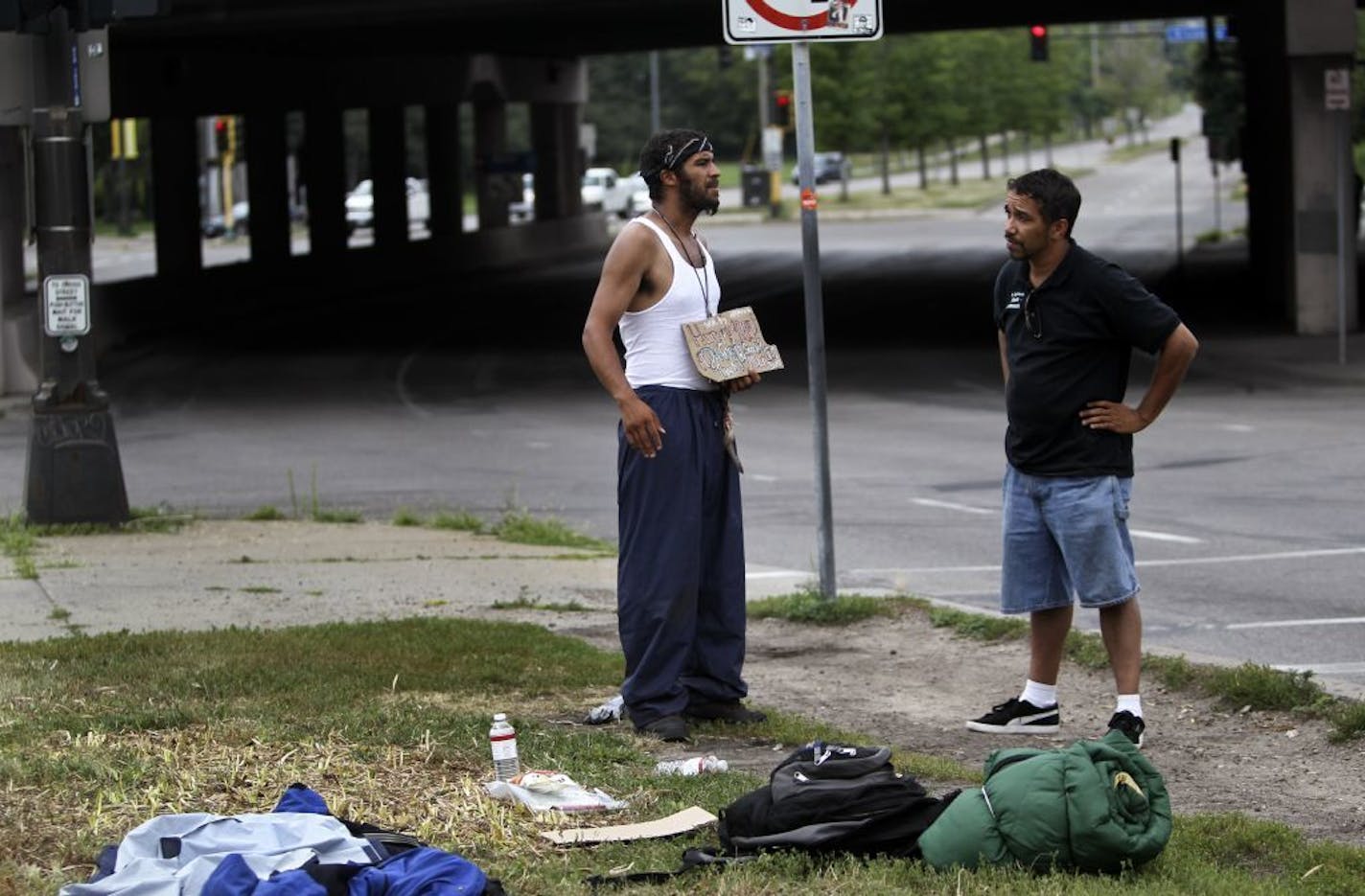 Street outreach workers like Joseph Desenclos at St. Stephen's Human Services, right, regularly canvass downtown for homeless residents and try to offer them advice and services. They say that the homeless can be prime targets for violence and Desenclos met Michael Taylor, 31, at N. 17th St. and Hennepin Ave. on his rounds checking on the homeless around the neighborhood Thursday, July 19, 2012, in Minneapolis, MN.Taylor has been homeless off and on for four years and hopes to get a car so he ca