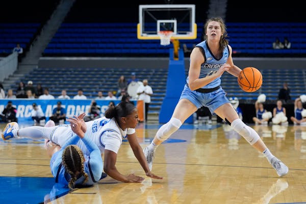 Creighton guard and former Lakeville North standout Lauren Jensen, right, prepares to shoot as UCLA guard Londynn Jones, top left, collides with Creig