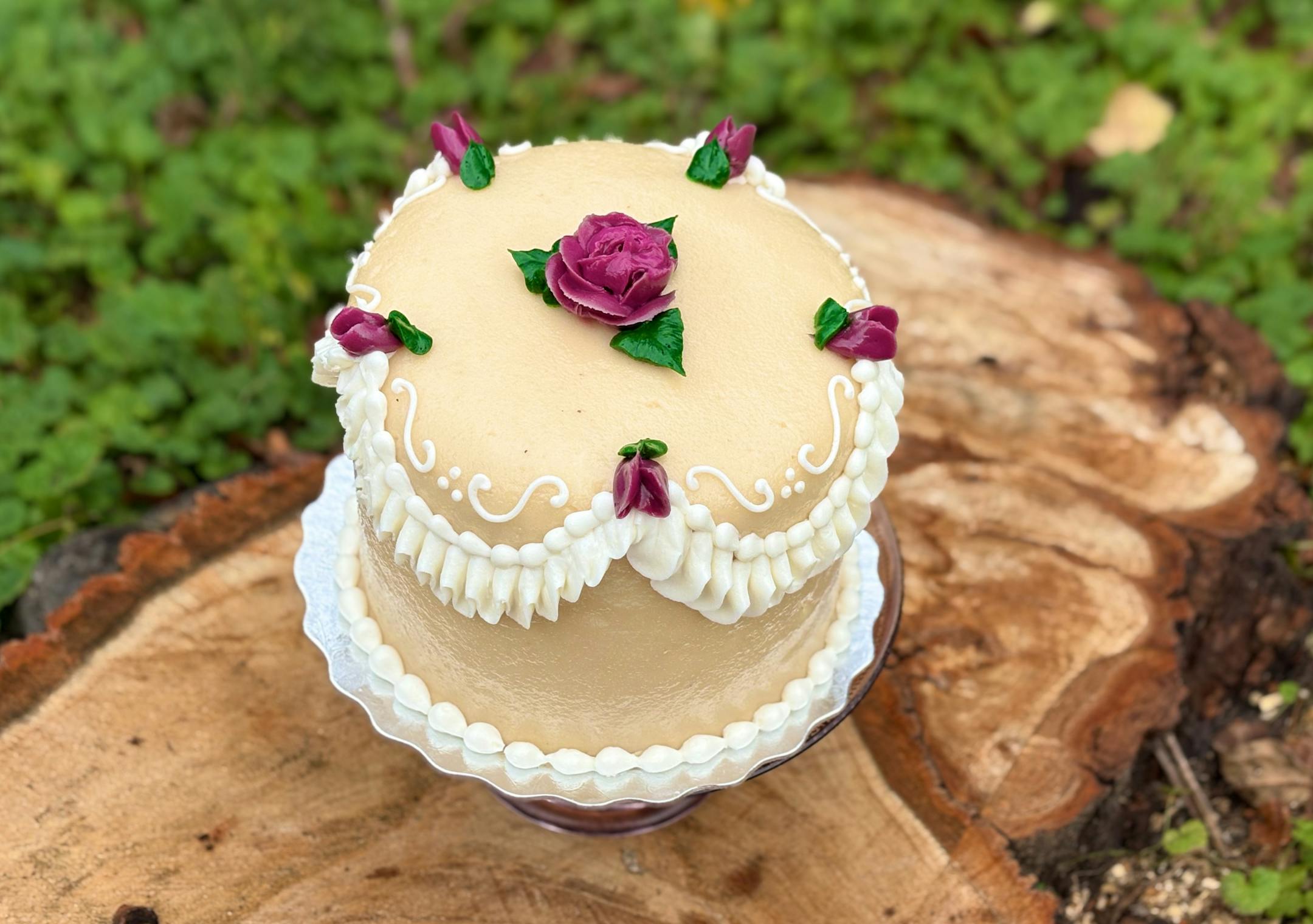 Lunds Princess Torte Cake, covered in white marzipan and decorated with frosting roses.