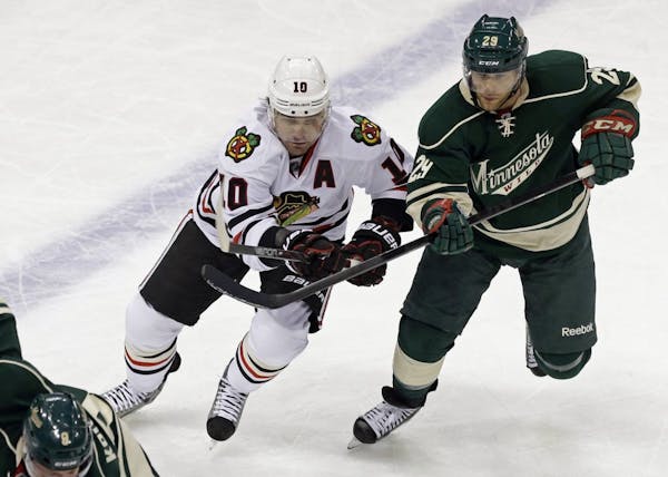 Jason Pominville (right) with Patrick Sharp of the Blackhawks.
