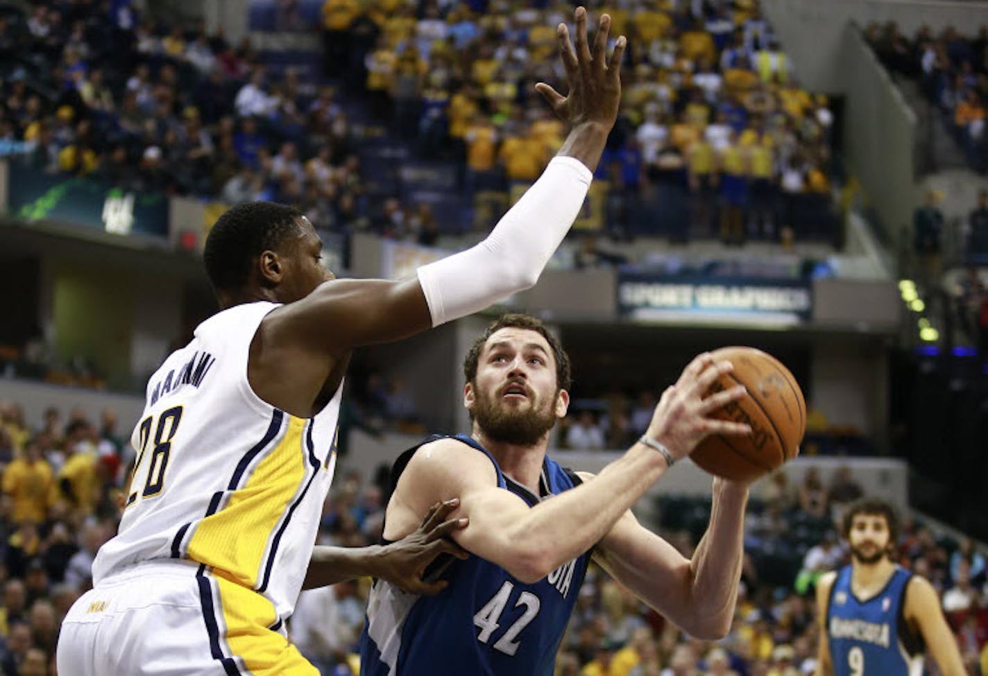 Kevin Love (42) moves with the ball near the basket against Indiana's Ian Mahinmi.