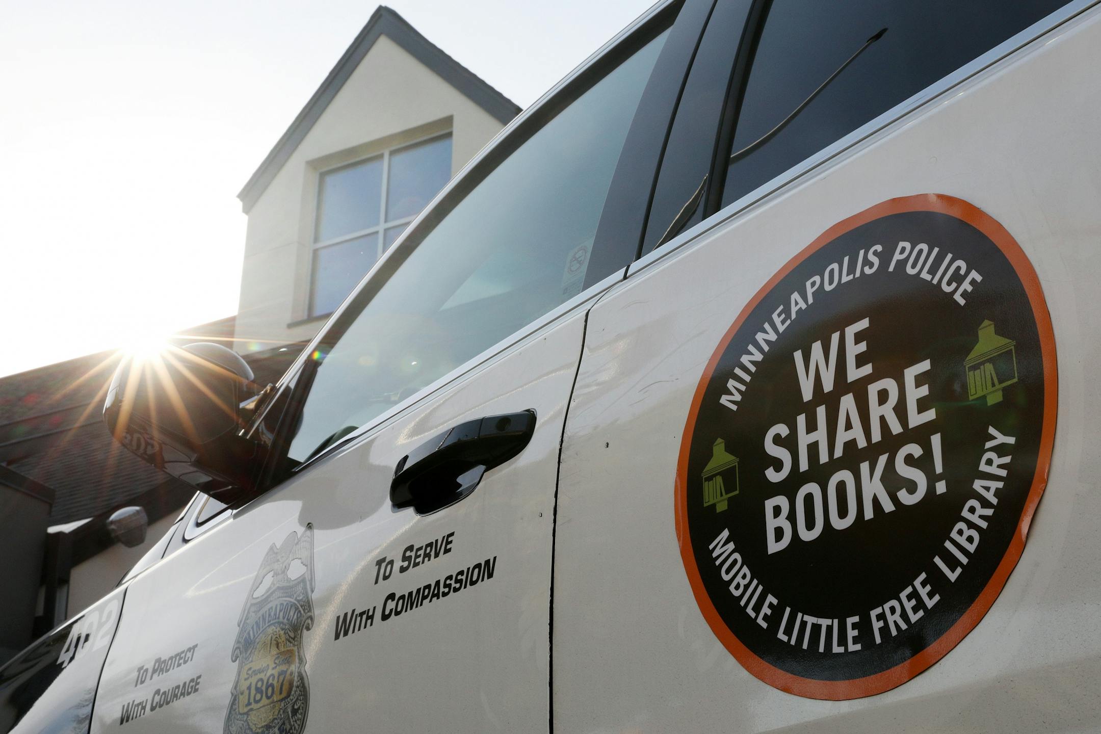 A new logo sat affixed to a patrol vehicle that will indicate that it is fitted with a Mobile Little Free Library carrying books to share with community members.