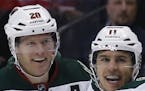Minnesota Wild left wing Zach Parise, center, celebrates scoring a goal with defenseman Ryan Suter, left, and center Charlie Coyle against the Colorad