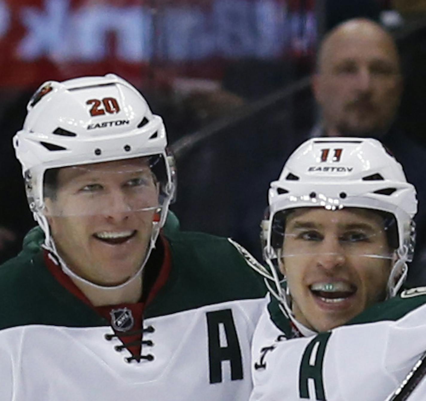 Minnesota Wild left wing Zach Parise, center, celebrates scoring a goal with defenseman Ryan Suter, left, and center Charlie Coyle against the Colorado Avalanche in the third period of an NHL hockey game Saturday, March 26, 2016, in Denver. The Wild won 4-0. (AP Photo/David Zalubowski) ORG XMIT: CODZ115