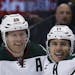 Minnesota Wild left wing Zach Parise, center, celebrates scoring a goal with defenseman Ryan Suter, left, and center Charlie Coyle against the Colorad
