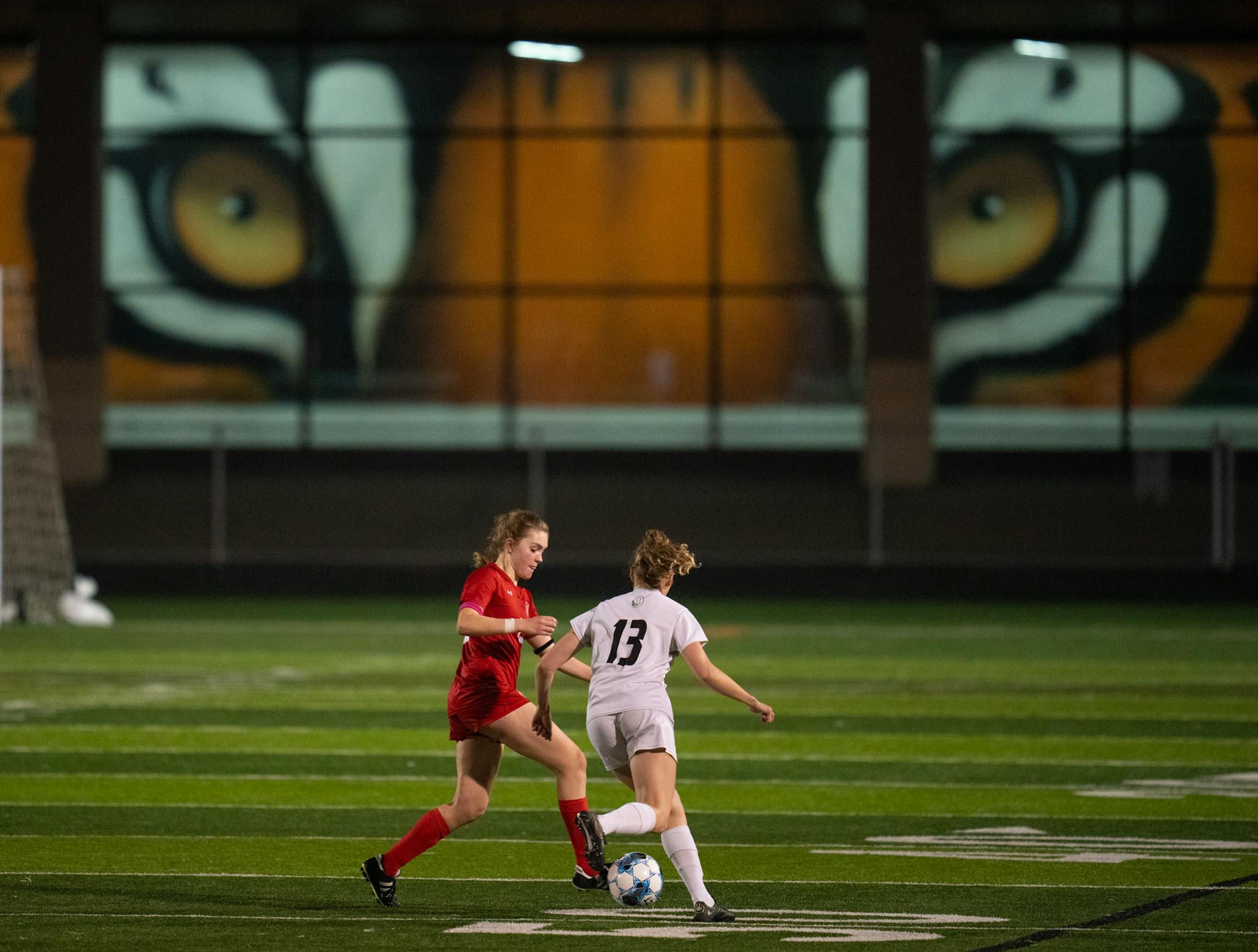 Benilde-St.Margaret's defender Anna Prange took Mankato East's Sophia Barnacle (13) off the ball at midfield in the second half.