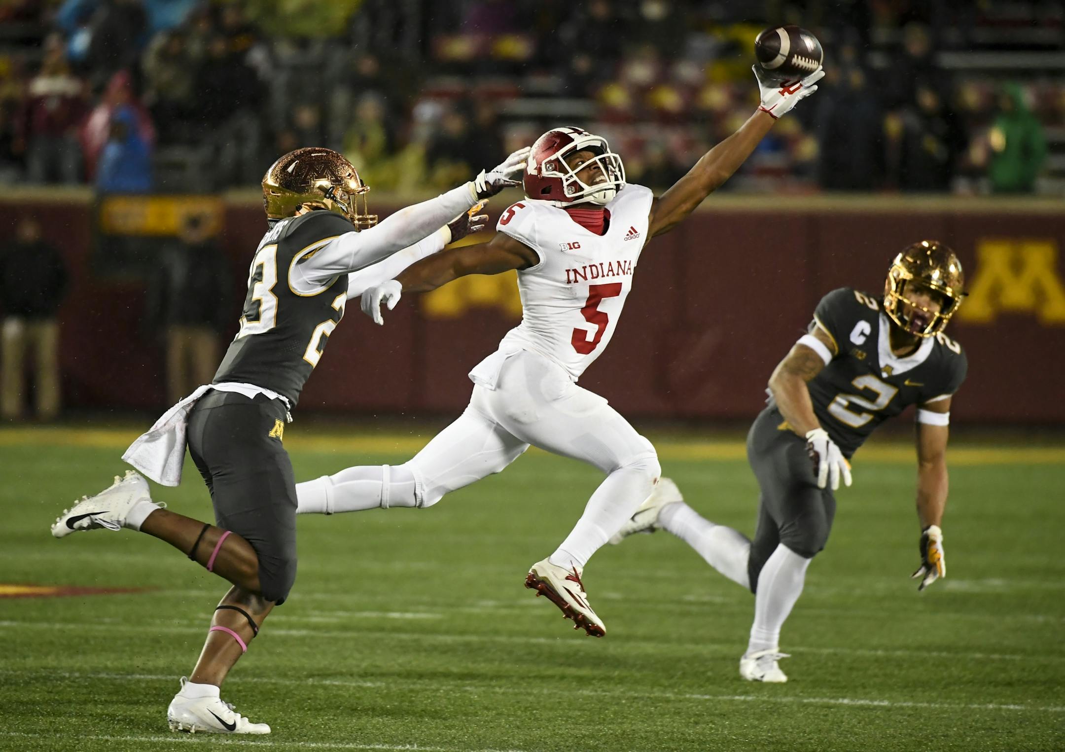 Indiana Hoosiers wide receiver J-Shun Harris II (5) was unable to complete a pass for a first down while being defended by Minnesota Golden Gophers defensive back Jordan Howden (23) and defensive back Jacob Huff (2) in the third quarter.