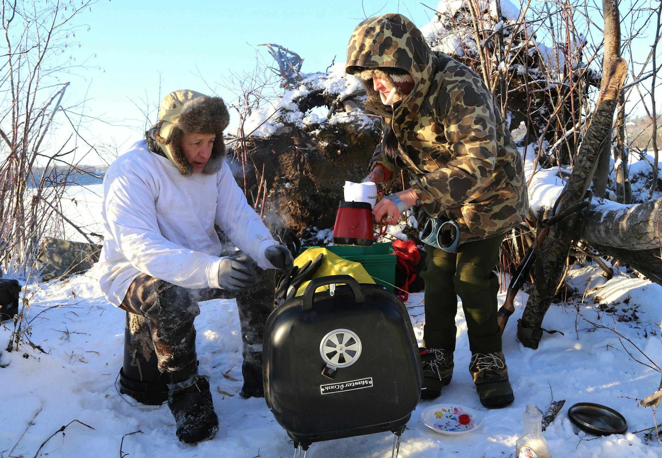 Hot breakfast was served on a cold morning as Galina Diller, right, and her husband, Wendell, sipped coffee while waiting for pancakes cooked on a charcoal fire.